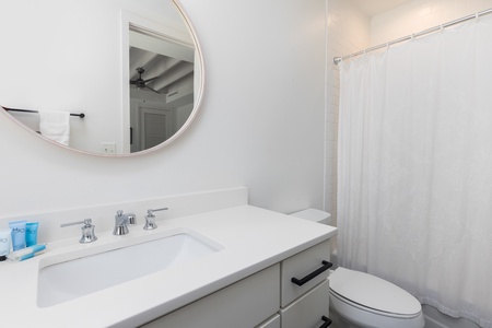 The king en suite bathroom features a large vanity and tub-shower combo