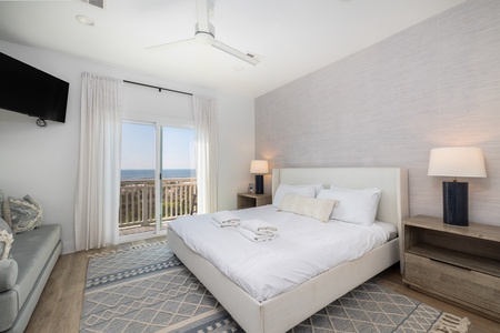 Your primary bedroom includes this large king bed and access to the private deck