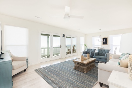Bright, airy living area with plenty of seating for family movie nights or game time.
