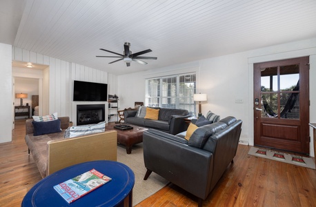 Inviting living room with plush seating, coastal décor, and large TV for cozy movie nights.