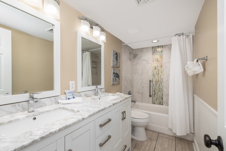 Your queen en suite includes a tub-shower combo and dual vanity
