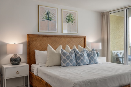Sink into crisp linens and coastal charm in your serene bedroom retreat, where tropical artwork and ocean-inspired accents create the perfect escape.