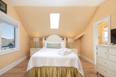 The third floor queen bedroom is a cozy retreat