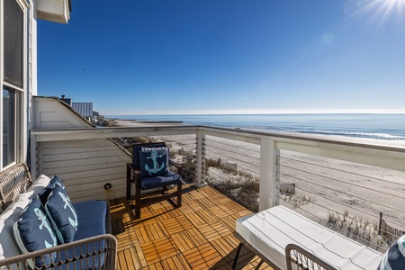 Sip your morning coffee on your private balcony with stunning oceanfront views and comfortable seating overlooking pristine sandy beaches.