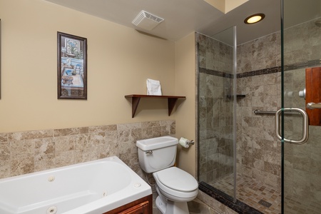 Your elegant primary bathroom includes a deep jacuzzi tub and glass walk-in shower