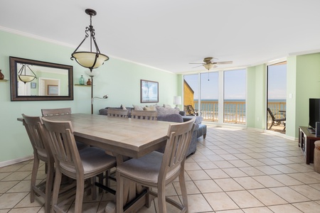 The dining room looks out to the living room and ocean beyond