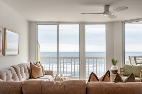 Sink into plush seating while ocean waves dance outside your floor-to-ceiling windows, creating the perfect backdrop for your coastal retreat.