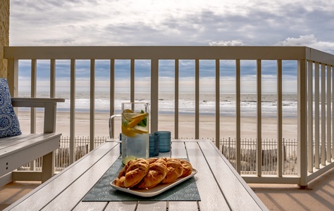 Savor fresh pastries and refreshing drinks on your private balcony while gazing at endless ocean waves and sandy shores.