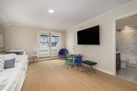 Unwind in your bright, family-friendly space with colorful seating and entertainment ready for cozy evenings together.