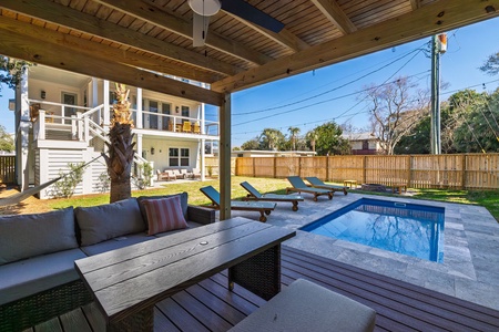 Your private poolside retreat awaits with comfortable lounge seating, sun loungers, and sparkling blue waters for ultimate relaxation.