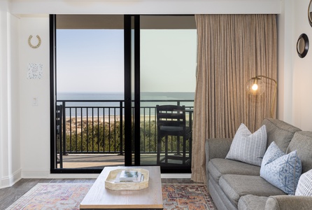 Sink into your private oceanfront sanctuary, where floor-to-ceiling windows frame endless sea views from your cozy living space.