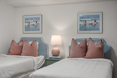 Sink into plush bedding with coastal artwork creating your perfect seaside retreat for two.