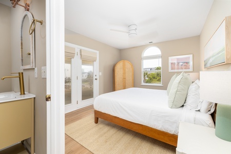 Another king bedroom features loads of access to the side deck and an en suite bathroom