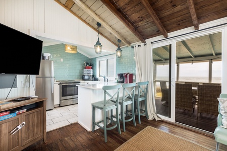 Your kitchen is equipped with stainless steel appliances and views of the ocean