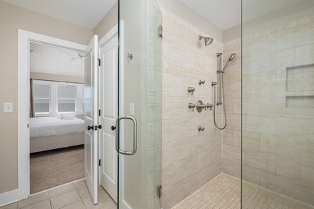 Step into your private spa-like shower with dual fixtures and gleaming glass enclosure, connected to your peaceful bedroom retreat.