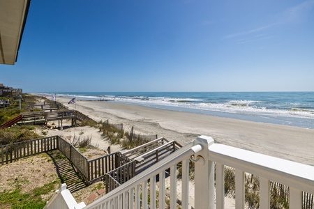 Stunning oceanfront view with direct beach access from this coastal retreat's private deck.