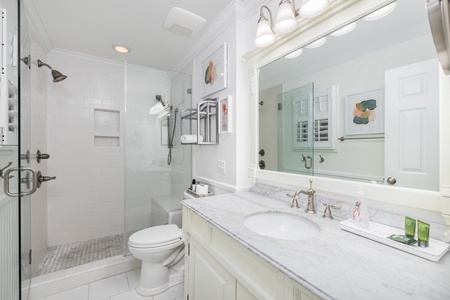 The primary en suite has an elegant walk-in shower and large vanity