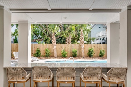 Kick back and watch the pool from the bar top