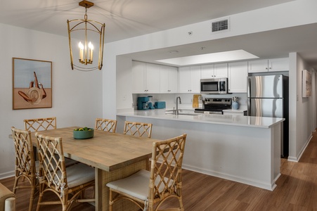 Your open-concept kitchen and dining space features modern appliances and warm wood tones, perfect for cooking and sharing meals together.