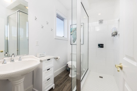 The bunk room en suite features a glass walk-in shower and single vanity
