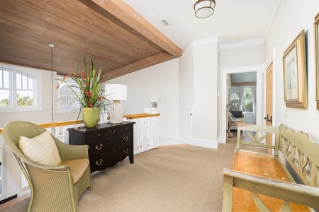 Take the stairs under the vaulted wood ceiling to your second floor