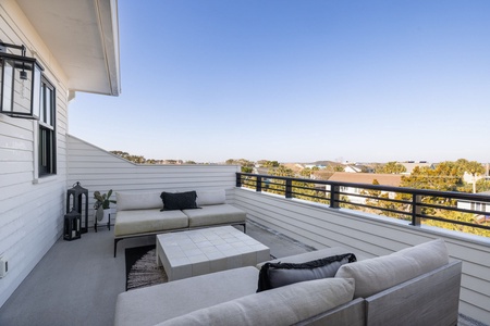 Relax on your private terrace with plush seating and peaceful neighborhood views stretching to the horizon.