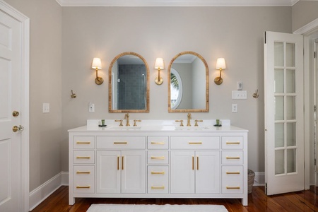 A dual vanity and arched mirrors are featured in your primary en suite bathroom