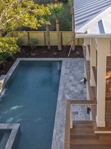 Your private pool awaits with tropical palms and wooden deck - perfect for morning swims and afternoon lounging.