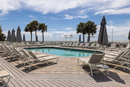 Oceanfront community pool with lounge chairs and panoramic views of the Atlantic