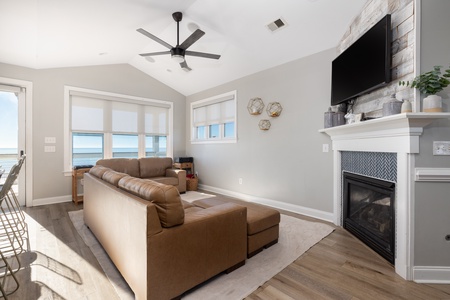 Sink into the leather sectional by your cozy fireplace while ocean breezes flow through. Perfect for relaxing evenings with loved ones.