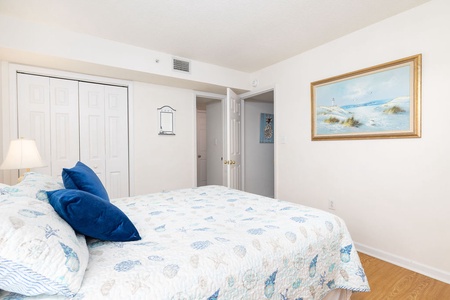 Your peaceful bedroom features a comfortable bed with coastal-inspired linens and soothing artwork that'll help you unwind after exploring.