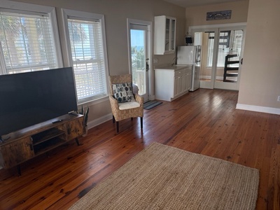 Relax in your open-concept living space with beautiful hardwood floors, modern kitchen, and natural light streaming through every window.