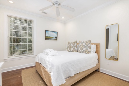 Beachy Queen bedroom features natural light and an en suite bathroom.