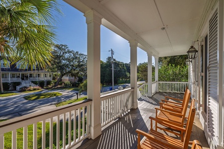 Relax in your wooden rocking chairs on this charming covered porch.