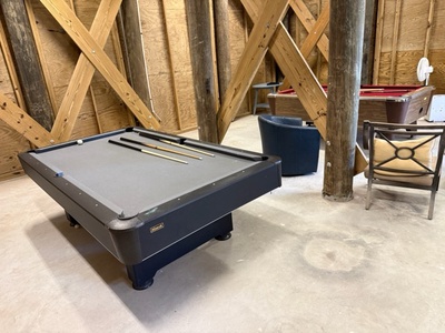 Challenge friends to a game in your private billiards room, where rustic timber beams create a cozy atmosphere for memorable evenings together.