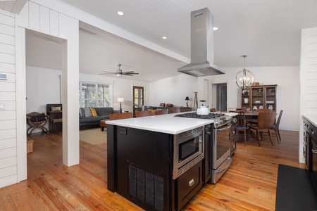 Sleek chef’s kitchen with gas range, farmhouse sink, and crisp white shiplap walls — the perfect blend of style and function in your Folly Beach vacation home.
