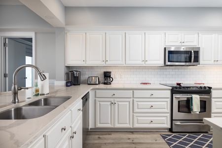 A fully-equipped kitchen features stainless steel appliances and everything you need to make your favorite vacation meals
