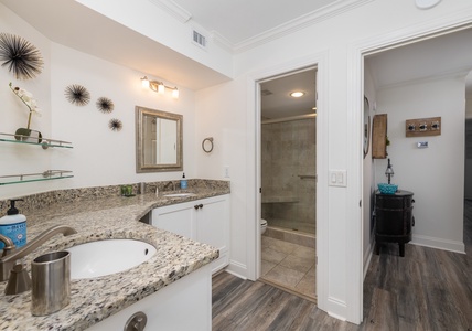 Your primary bathroom has two vanities and a walk-in shower
