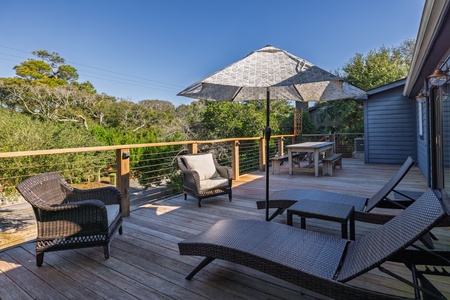 An expansive deck overlooks your lush, tropical landscape