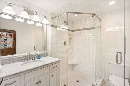The ground level features two additional bathrooms with full showers
