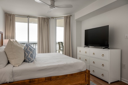 Drift off to sleep in your serene bedroom with plush bedding, ocean breeze from your private balcony, and modern amenities for ultimate comfort.