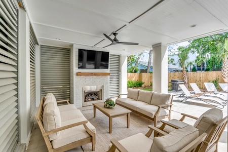 Unwind in this elegant covered patio overlooking the pool area
