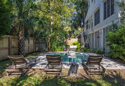 Catch some rays next to the pool on this cozy patio.