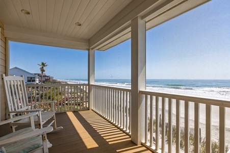 Your private balcony offers stunning ocean views where you can sip morning coffee in the rocking chair while watching waves roll in.
