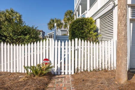 Enter through the white picket fence to reach your pool