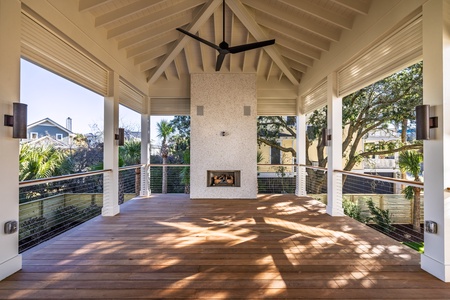 Your covered outdoor pavilion features soaring beams, a cozy fireplace, and panoramic views through tropical trees.