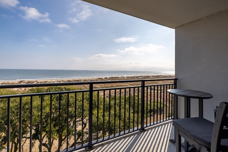 Stunning oceanfront balcony with direct beach views and outdoor seating for your perfect coastal getaway.