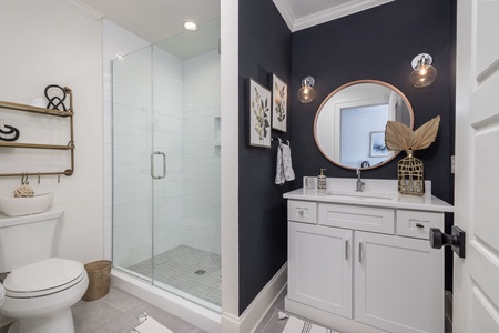 The queen bedroom features an en suite bathroom with tiled walk-in shower and modern vanity