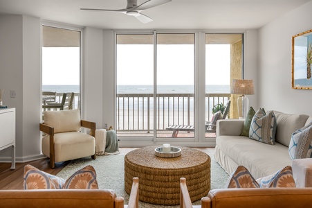 Relax in this bright living room where ocean breezes flow through sliding doors to your private balcony overlooking the sea.