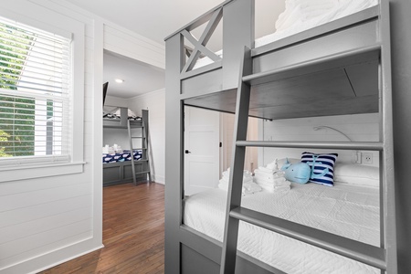 Your kids will love this fun bunk room with built-in beds and wall-mounted TV